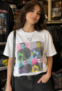 CASH Graphic T-Shirt worn by a model, angled front view showing the white short sleeve tee with graphic print